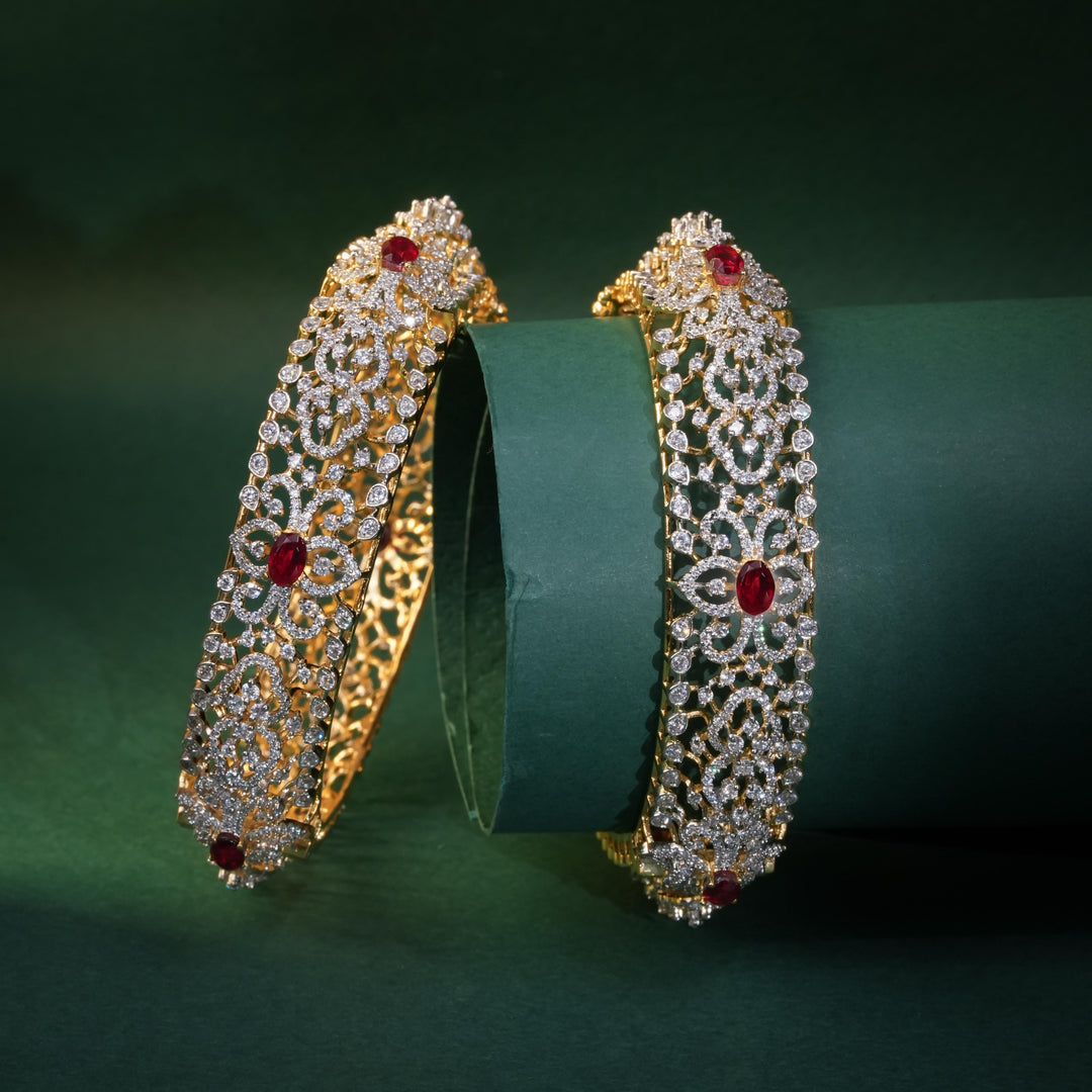 92.5 silver CZ bangles with floral motifs, and semi-precious ruby stones by Sri Fine Jewellery, Hyderabad.
(https://www.srifinejewellery.com)
