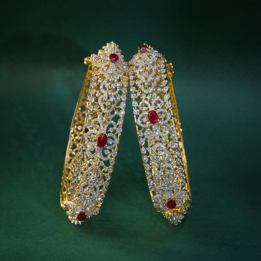 92.5 silver CZ bangles with floral motifs, and semi-precious ruby stones by Sri Fine Jewellery, Hyderabad.
(https://www.srifinejewellery.com)