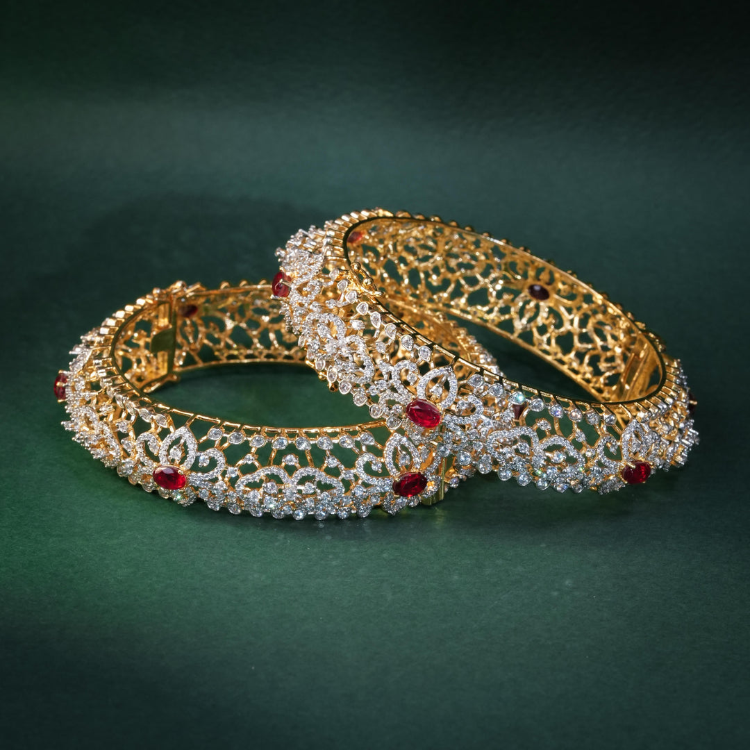 92.5 silver CZ bangles with floral motifs, and semi-precious ruby stones by Sri Fine Jewellery, Hyderabad.
(https://www.srifinejewellery.com)