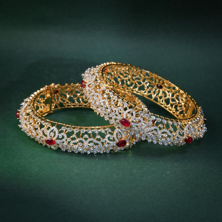 92.5 silver CZ bangles with floral motifs, and semi-precious ruby stones by Sri Fine Jewellery, Hyderabad.
(https://www.srifinejewellery.com)