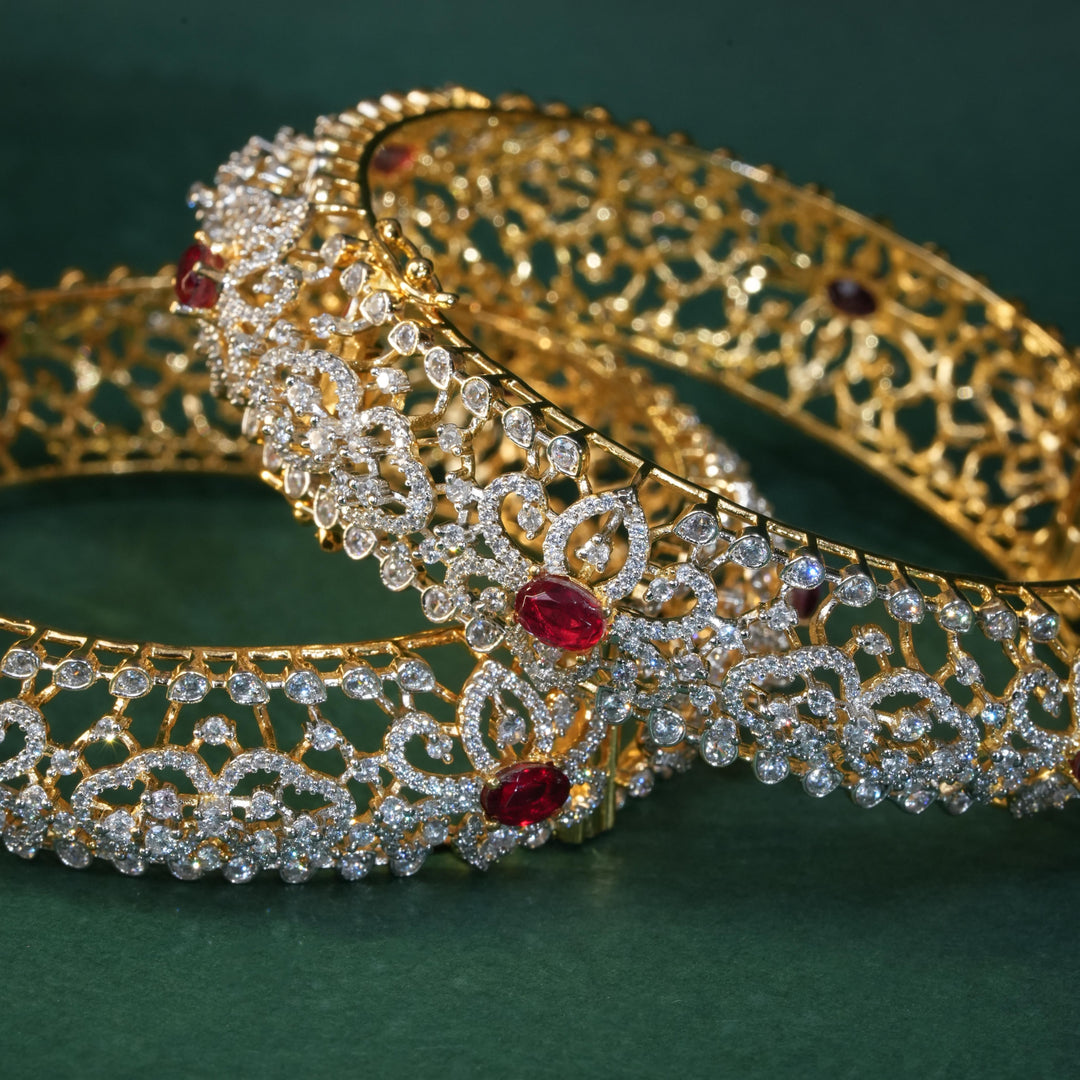 92.5 silver CZ bangles with floral motifs, and semi-precious ruby stones by Sri Fine Jewellery, Hyderabad.
(https://www.srifinejewellery.com)