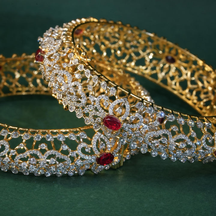 92.5 silver CZ bangles with floral motifs, and semi-precious ruby stones by Sri Fine Jewellery, Hyderabad.
(https://www.srifinejewellery.com)
