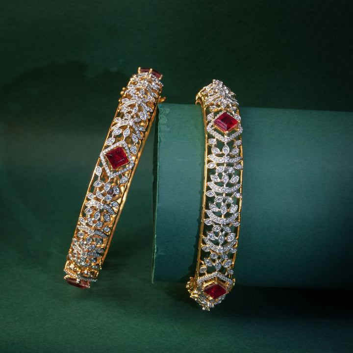 92.5 silver CZ bangles with floral motifs, and semi-precious ruby stones by Sri Fine Jewellery, Hyderabad.
(https://www.srifinejewellery.com)