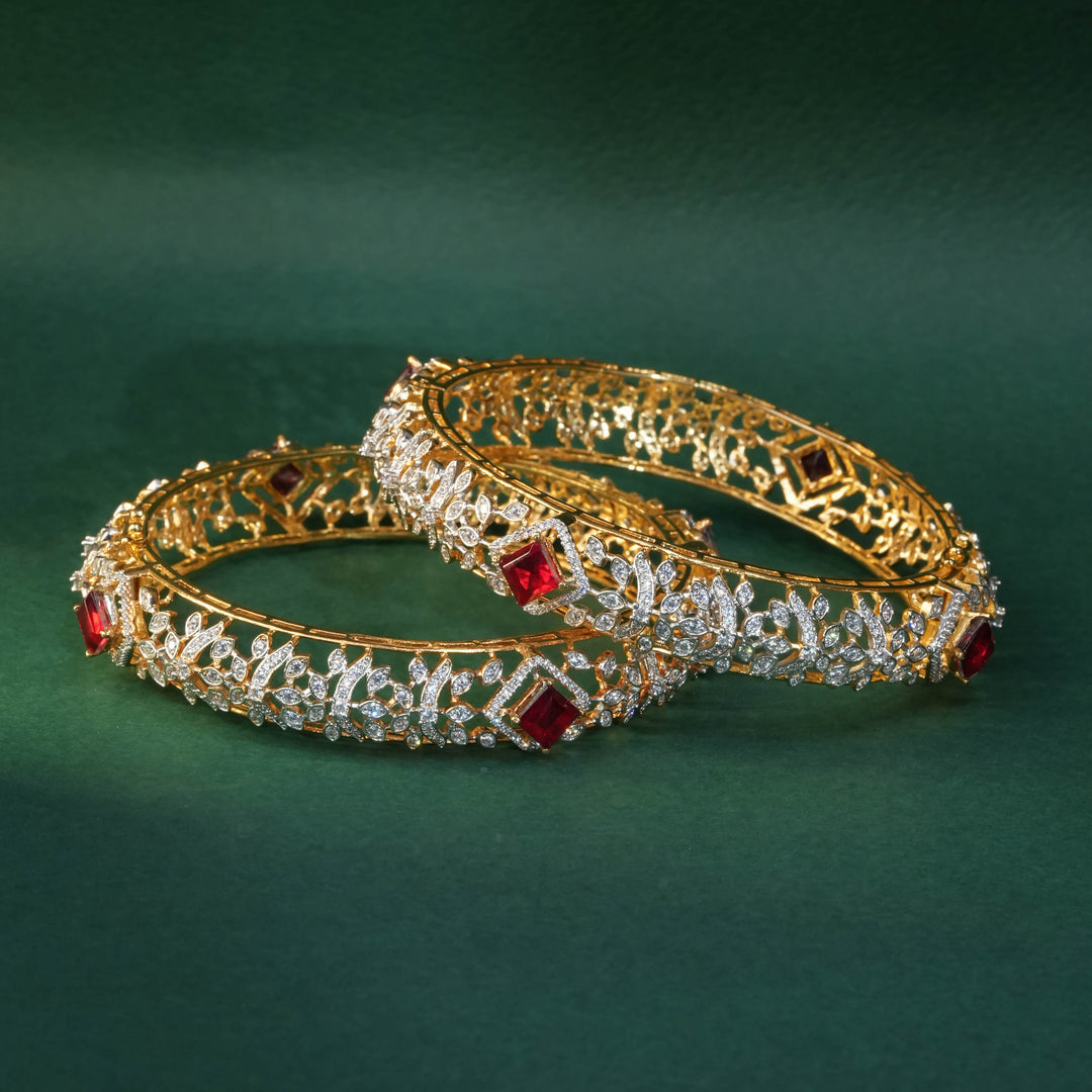 92.5 silver CZ bangles with floral motifs, and semi-precious ruby stones by Sri Fine Jewellery, Hyderabad.
(https://www.srifinejewellery.com)