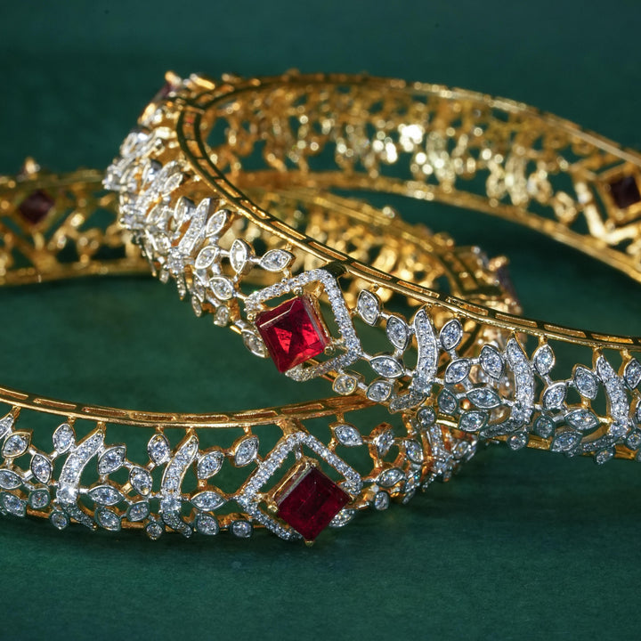 92.5 silver CZ bangles with floral motifs, and semi-precious ruby stones by Sri Fine Jewellery, Hyderabad.
(https://www.srifinejewellery.com)