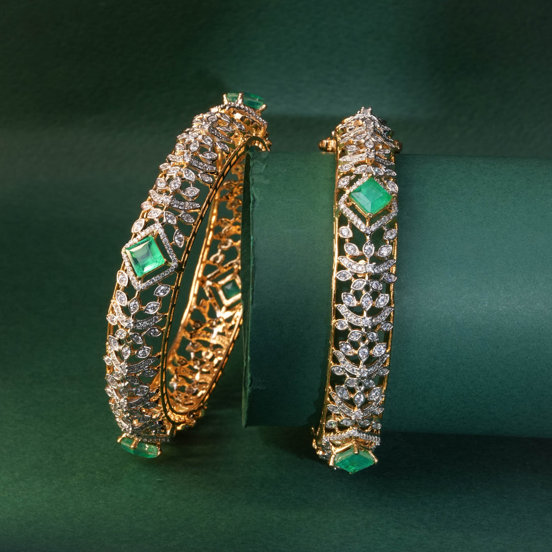 92.5 silver CZ bangles with floral motifs, and semi-precious russian emerald stones by Sri Fine Jewellery, Hyderabad.
(https://www.srifinejewellery.com)