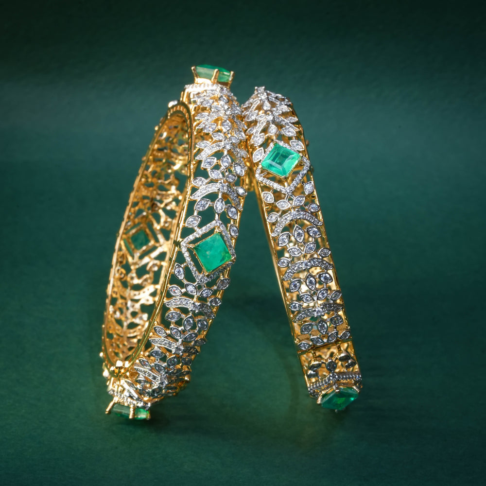 92.5 silver CZ bangles with floral motifs, and semi-precious russian emerald stones by Sri Fine Jewellery, Hyderabad.
(https://www.srifinejewellery.com)