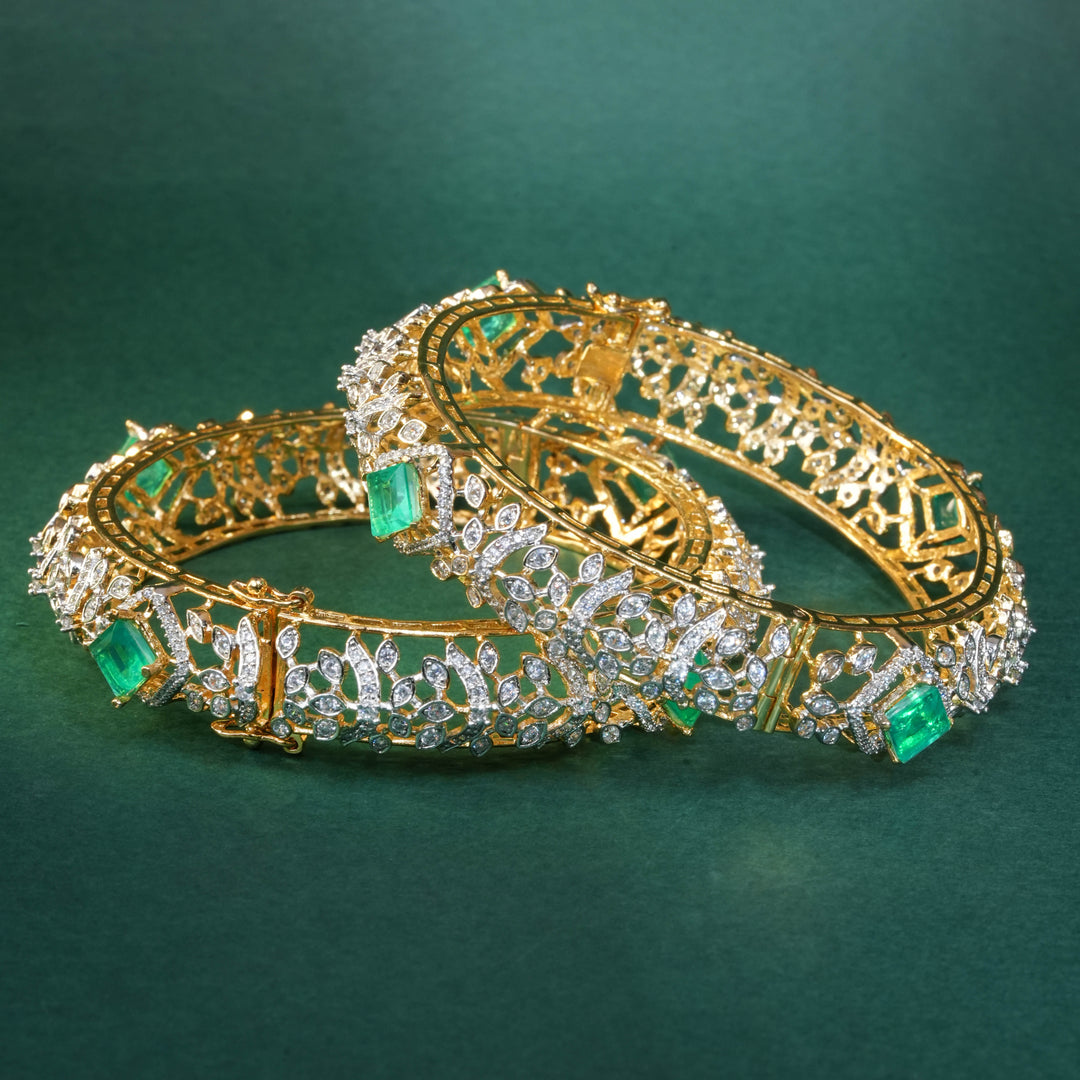 92.5 silver CZ bangles with floral motifs, and semi-precious russian emerald stones by Sri Fine Jewellery, Hyderabad.
(https://www.srifinejewellery.com)