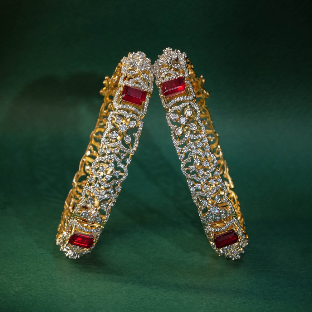 92.5 silver CZ bangles with floral motifs, and semi-precious ruby stones by Sri Fine Jewellery, Hyderabad.
(https://www.srifinejewellery.com)