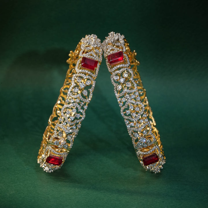 92.5 silver CZ bangles with floral motifs, and semi-precious ruby stones by Sri Fine Jewellery, Hyderabad.
(https://www.srifinejewellery.com)