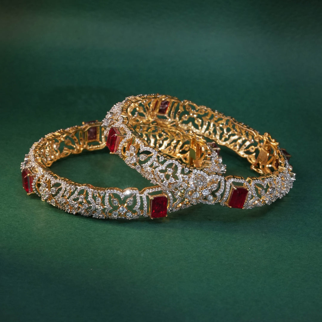 92.5 silver CZ bangles with floral motifs, and semi-precious ruby stones by Sri Fine Jewellery, Hyderabad.
(https://www.srifinejewellery.com)