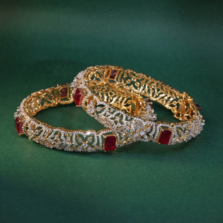 92.5 silver CZ bangles with floral motifs, and semi-precious ruby stones by Sri Fine Jewellery, Hyderabad.
(https://www.srifinejewellery.com)