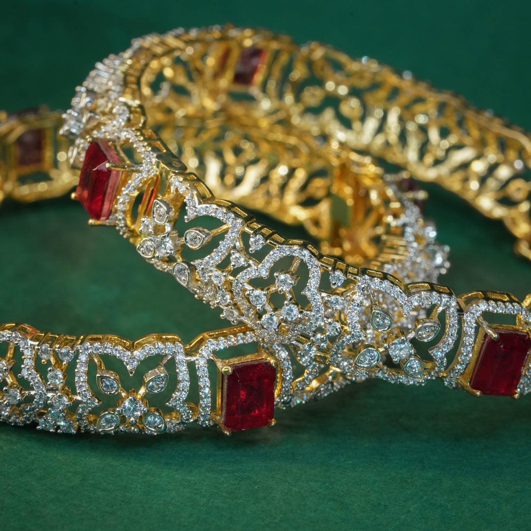 92.5 silver CZ bangles with floral motifs, and semi-precious ruby stones by Sri Fine Jewellery, Hyderabad.
(https://www.srifinejewellery.com)