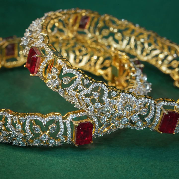 92.5 silver CZ bangles with floral motifs, and semi-precious ruby stones by Sri Fine Jewellery, Hyderabad.
(https://www.srifinejewellery.com)