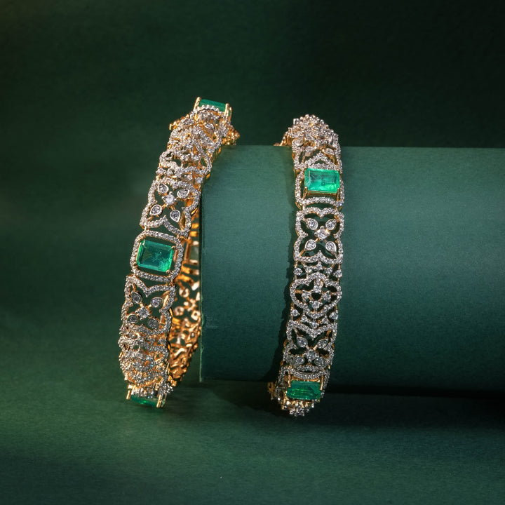92.5 silver CZ bangles with floral motifs, and semi-precious russian emerald stones by Sri Fine Jewellery, Hyderabad.
(https://www.srifinejewellery.com)