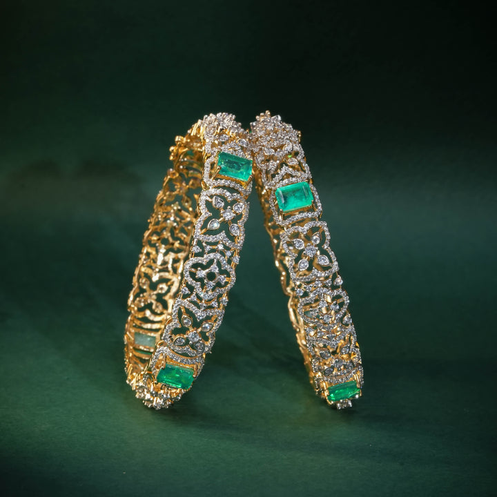 92.5 silver CZ bangles with floral motifs, and semi-precious russian emerald stones by Sri Fine Jewellery, Hyderabad.
(https://www.srifinejewellery.com)