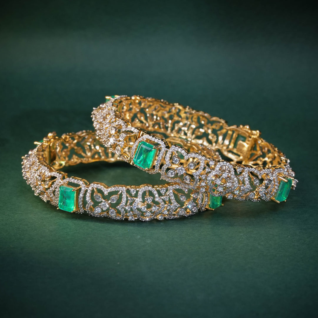 92.5 silver CZ bangles with floral motifs, and semi-precious russian emerald stones by Sri Fine Jewellery, Hyderabad.
(https://www.srifinejewellery.com)