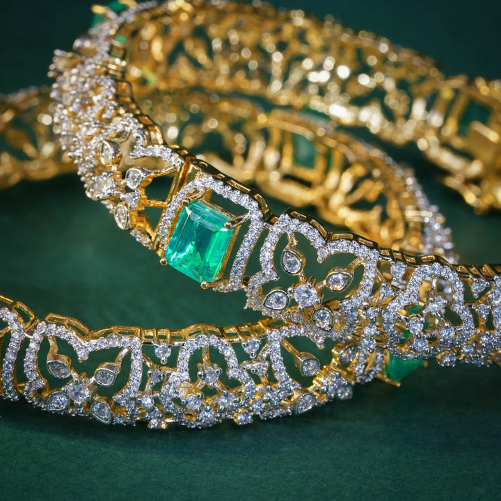92.5 silver CZ bangles with floral motifs, and semi-precious russian emerald stones by Sri Fine Jewellery, Hyderabad.
(https://www.srifinejewellery.com)