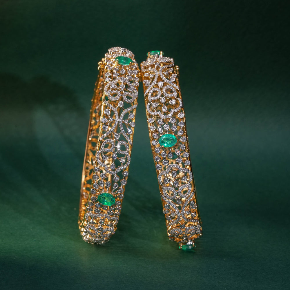 92.5 silver CZ bangles with floral motifs, and semi-precious russian emerald stones by Sri Fine Jewellery, Hyderabad.
(https://www.srifinejewellery.com)