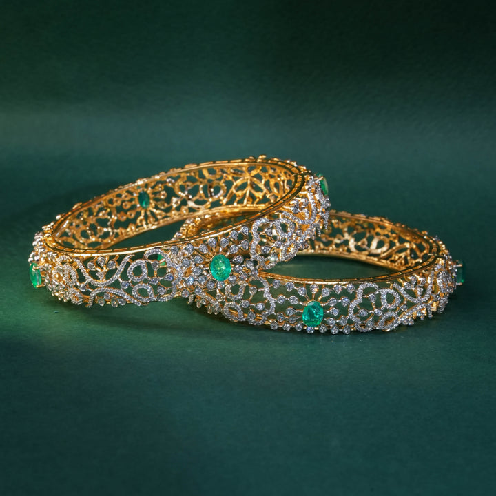 92.5 silver CZ bangles with floral motifs, and semi-precious russian emerald stones by Sri Fine Jewellery, Hyderabad.
(https://www.srifinejewellery.com)