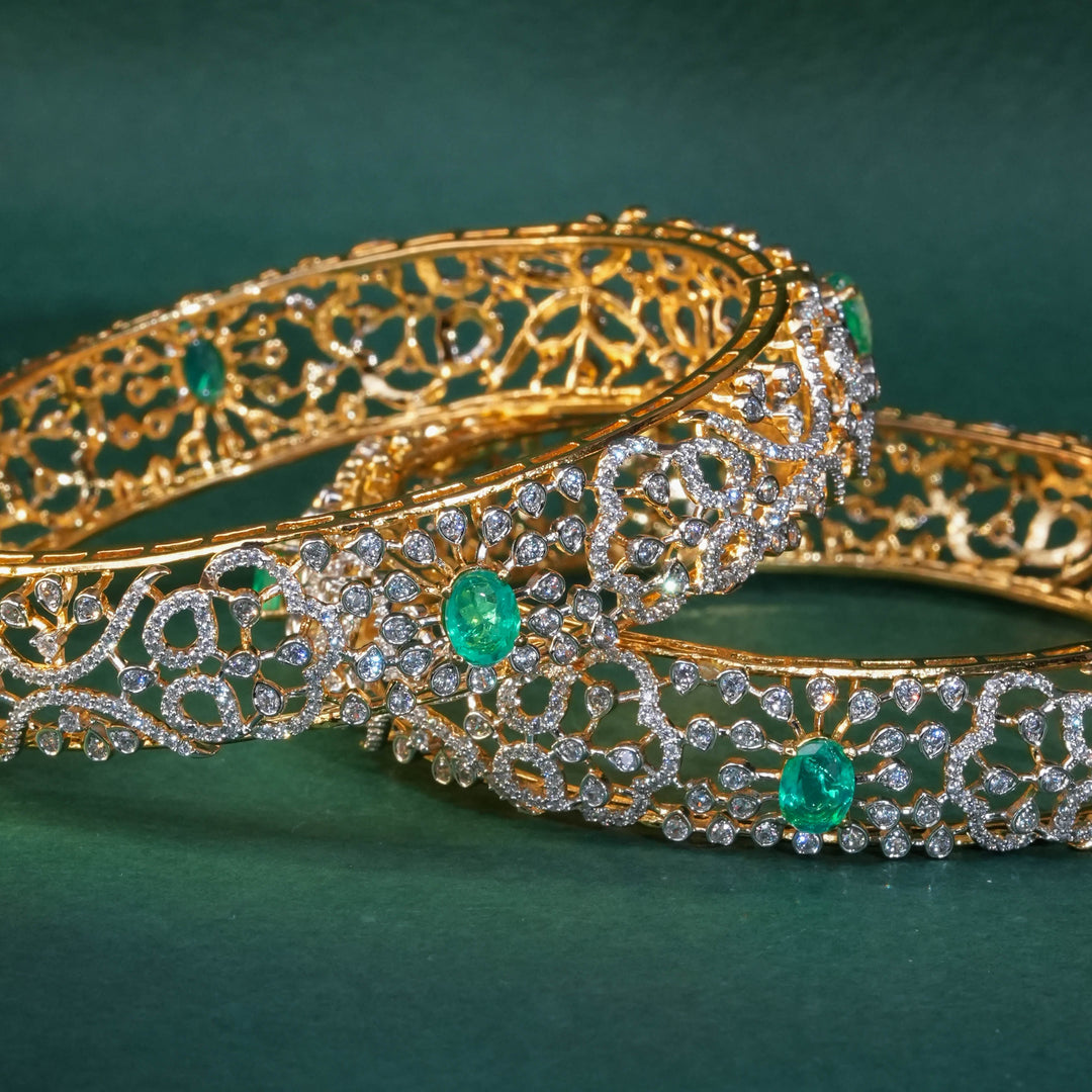 92.5 silver CZ bangles with floral motifs, and semi-precious russian emerald stones by Sri Fine Jewellery, Hyderabad.
(https://www.srifinejewellery.com)