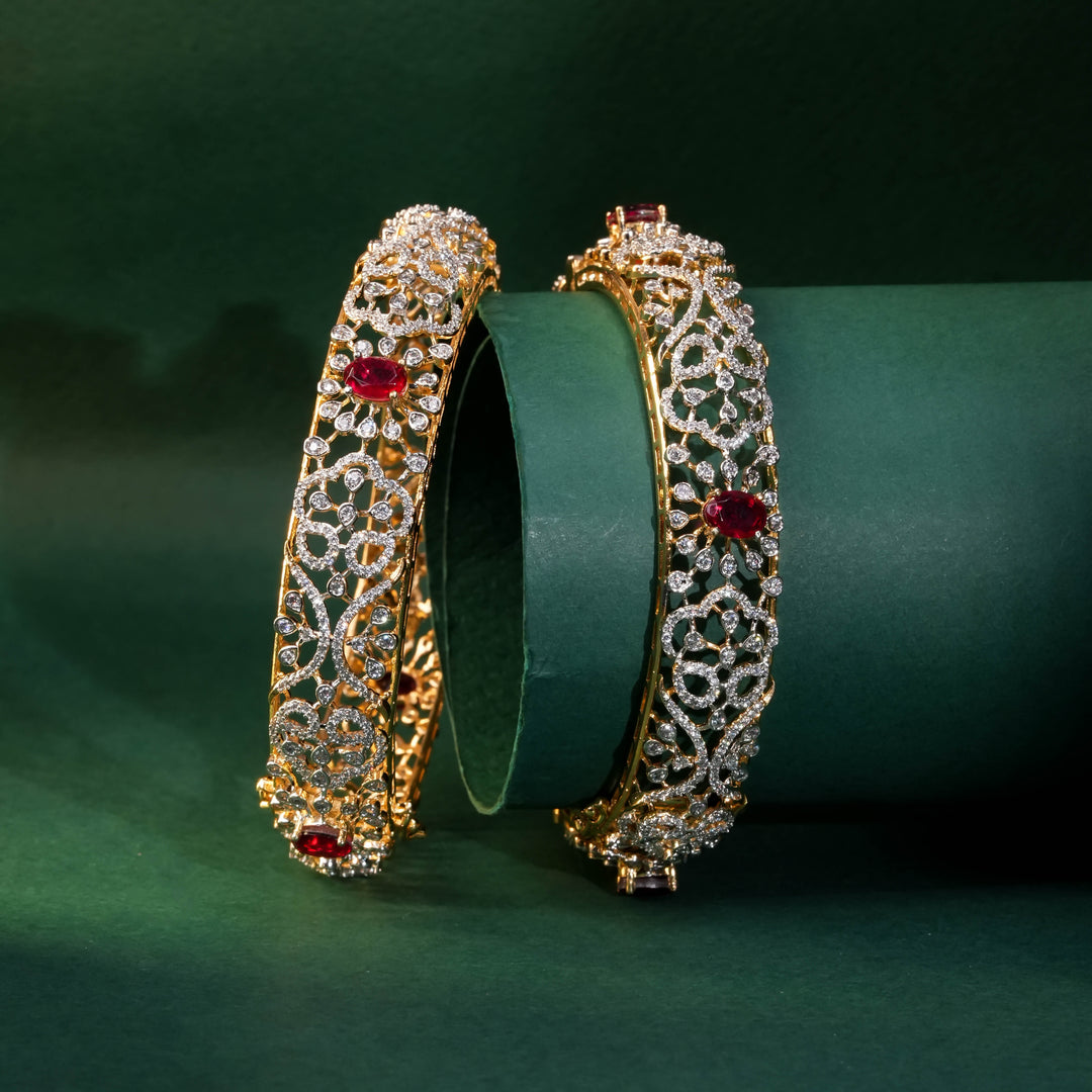 92.5 silver CZ bangles with floral motifs, and semi-precious ruby stones by Sri Fine Jewellery, Hyderabad.
(https://www.srifinejewellery.com)
