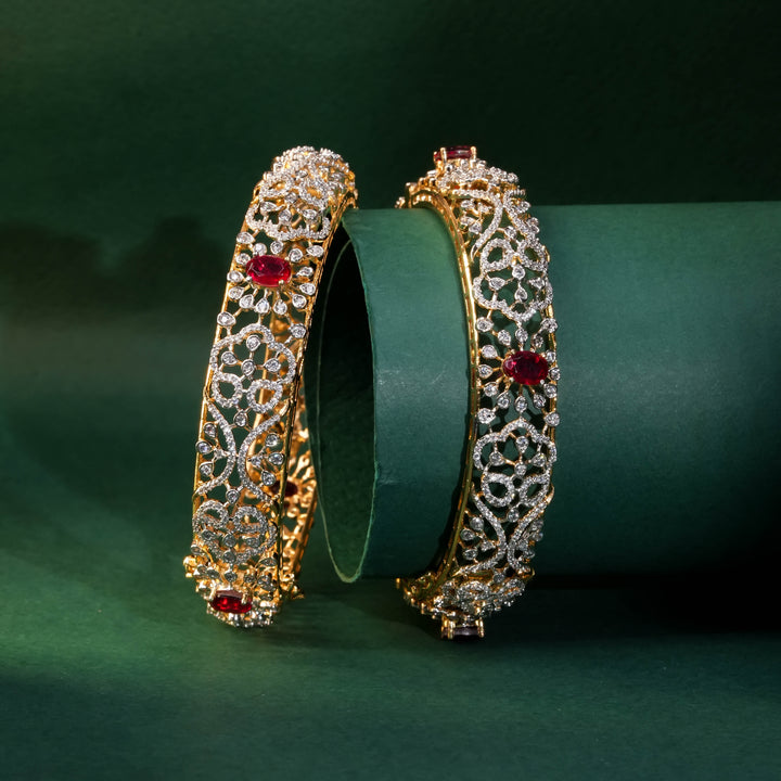 92.5 silver CZ bangles with floral motifs, and semi-precious ruby stones by Sri Fine Jewellery, Hyderabad.
(https://www.srifinejewellery.com)