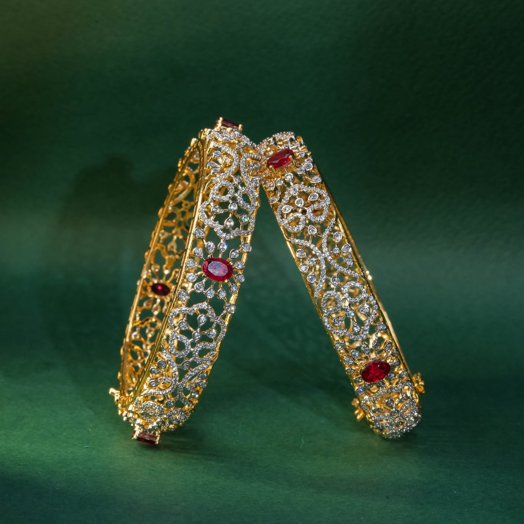 92.5 silver CZ bangles with floral motifs, and semi-precious ruby stones by Sri Fine Jewellery, Hyderabad.
(https://www.srifinejewellery.com)