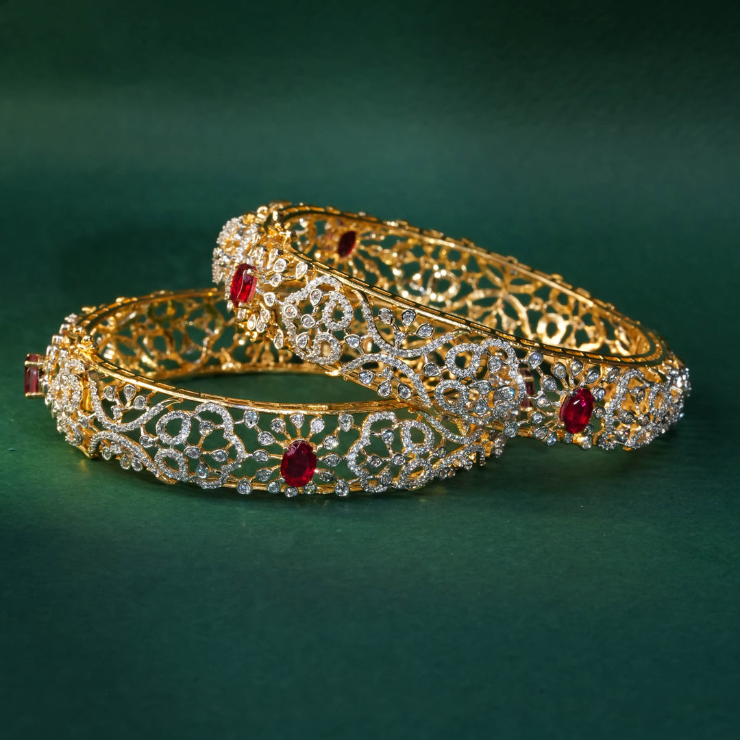 92.5 silver CZ bangles with floral motifs, and semi-precious ruby stones by Sri Fine Jewellery, Hyderabad.
(https://www.srifinejewellery.com)