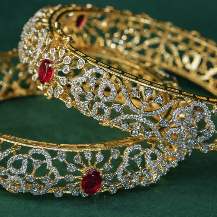 92.5 silver CZ bangles with floral motifs, and semi-precious ruby stones by Sri Fine Jewellery, Hyderabad.
(https://www.srifinejewellery.com)