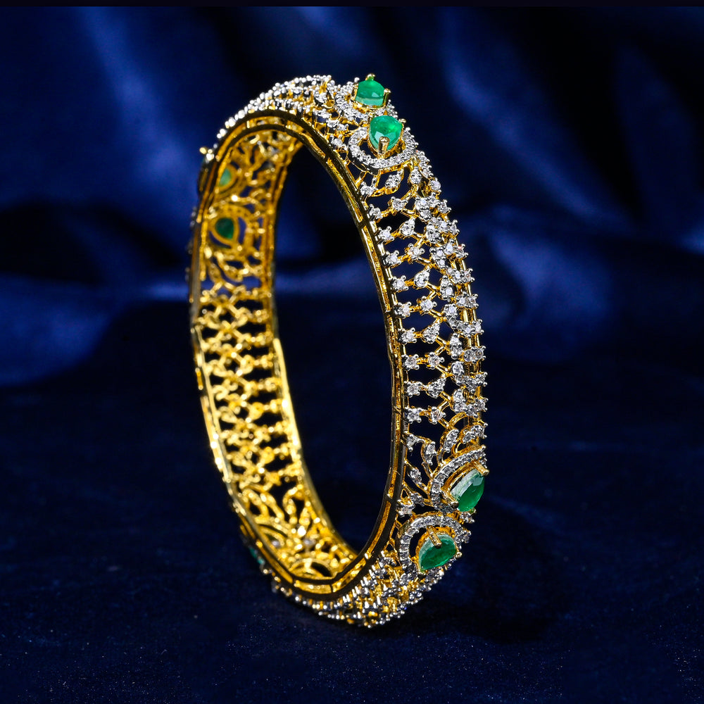 92.5 silver CZ bangles with floral motifs, and semi-precious emerald stones by Sri Fine Jewellery, Hyderabad.
(https://www.srifinejewellery.com)