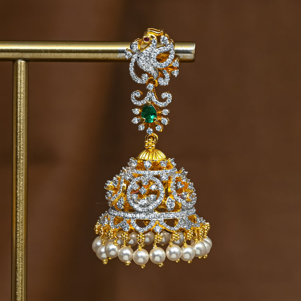 Close-up of premium 92.5 silver cz emerald jhumka earrings with intricate peacock detailing and pearl drops by Sri Fine Jewellery, Hyderabad 
