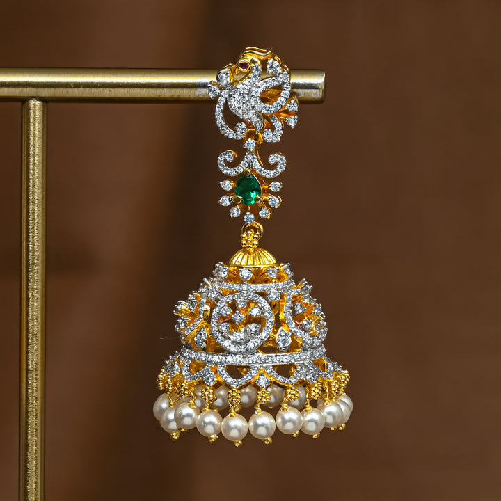 Close-up of premium 92.5 silver cz emerald jhumka earrings with intricate peacock detailing and pearl drops by Sri Fine Jewellery, Hyderabad 