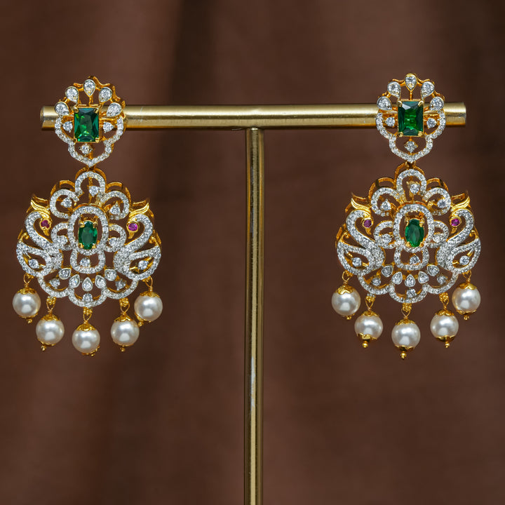 Full view of premium 92.5 silver cz emerald earrings with intricate peacock design detailing and pearl drops by Sri Fine Jewellery, Hyderabad (https://srifinejewellery.com)