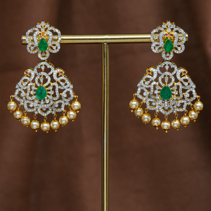 Full view of premium 92.5 silver cz emerald earrings with intricate peacock design detailing and pearl drops by Sri Fine Jewellery, Hyderabad (https://srifinejewellery.com)