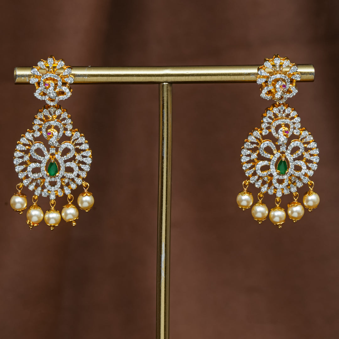 Full view of premium 92.5 silver cz emerald earrings with intricate peacock detailing and pearl drops by Sri Fine Jewellery, Hyderabad (https://srifinejewellery.com)