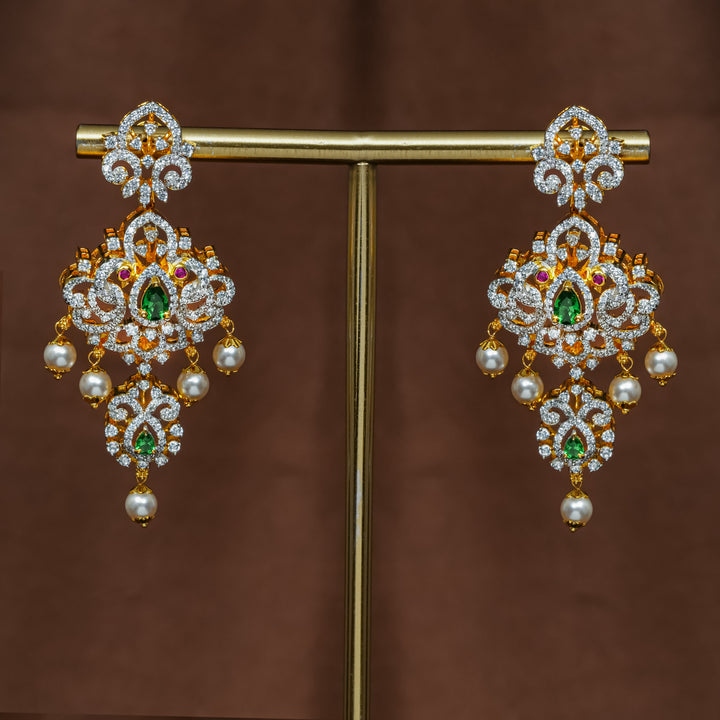 Full view of premium 92.5 silver cz emerald earrings with intricate peacock design detailing and pearl drops by Sri Fine Jewellery, Hyderabad (https://srifinejewellery.com)