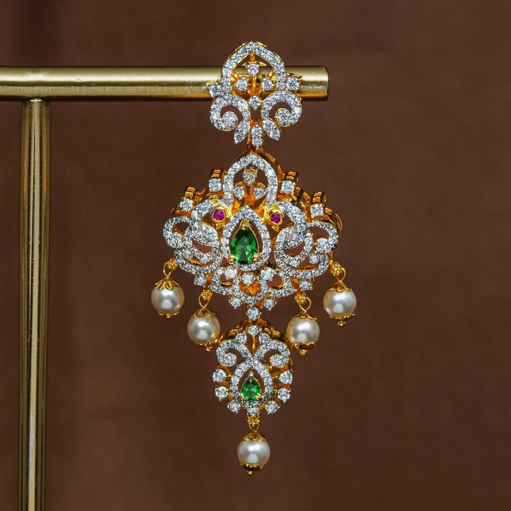 Close-up view of premium 92.5 silver cz emerald earrings with intricate peacock design detailing and pearl drops by Sri Fine Jewellery, Hyderabad (https://srifinejewellery.com)