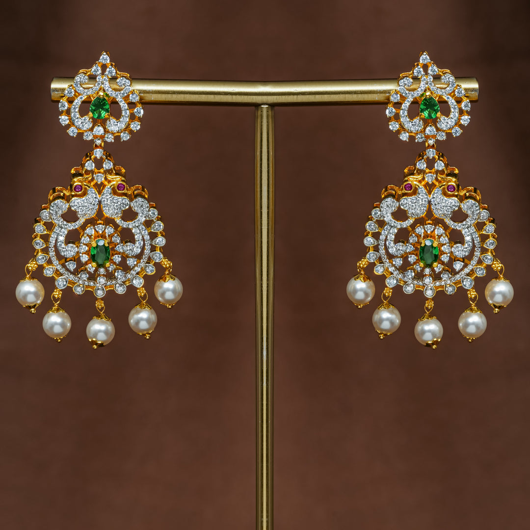 Close-up view of premium 92.5 silver cz emerald earrings with intricate peacock design detailing and pearl drops by Sri Fine Jewellery, Hyderabad (https://srifinejewellery.com)
