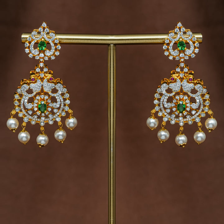 Close-up view of premium 92.5 silver cz emerald earrings with intricate peacock design detailing and pearl drops by Sri Fine Jewellery, Hyderabad (https://srifinejewellery.com)