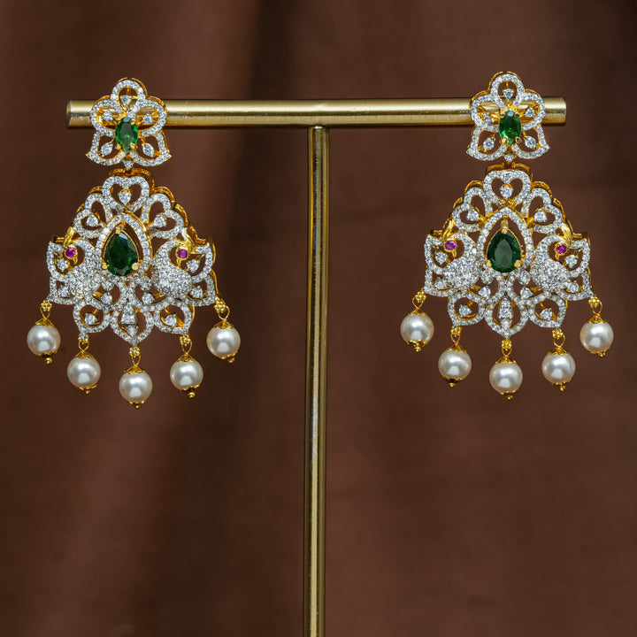 Full view of premium 92.5 silver cz emerald earrings with intricate peacock design detailing and pearl drops by Sri Fine Jewellery, Hyderabad (https://srifinejewellery.com)