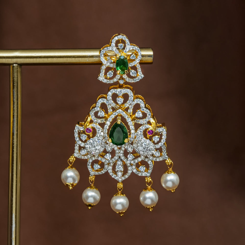 Close-up view of premium 92.5 silver cz emerald earrings with intricate peacock design detailing and pearl drops by Sri Fine Jewellery, Hyderabad (https://srifinejewellery.com)