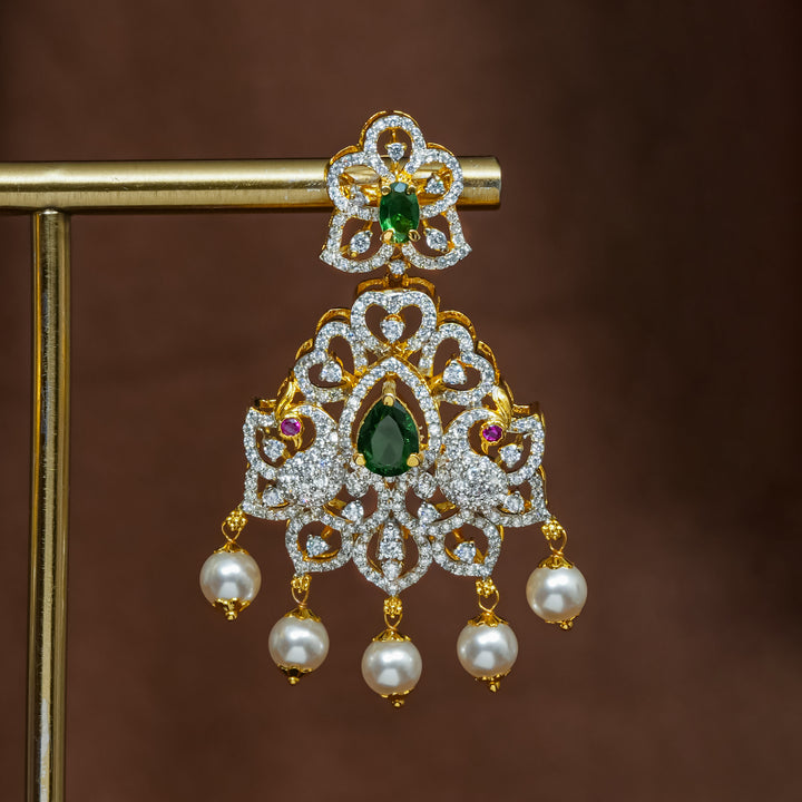 Close-up view of premium 92.5 silver cz emerald earrings with intricate peacock design detailing and pearl drops by Sri Fine Jewellery, Hyderabad (https://srifinejewellery.com)