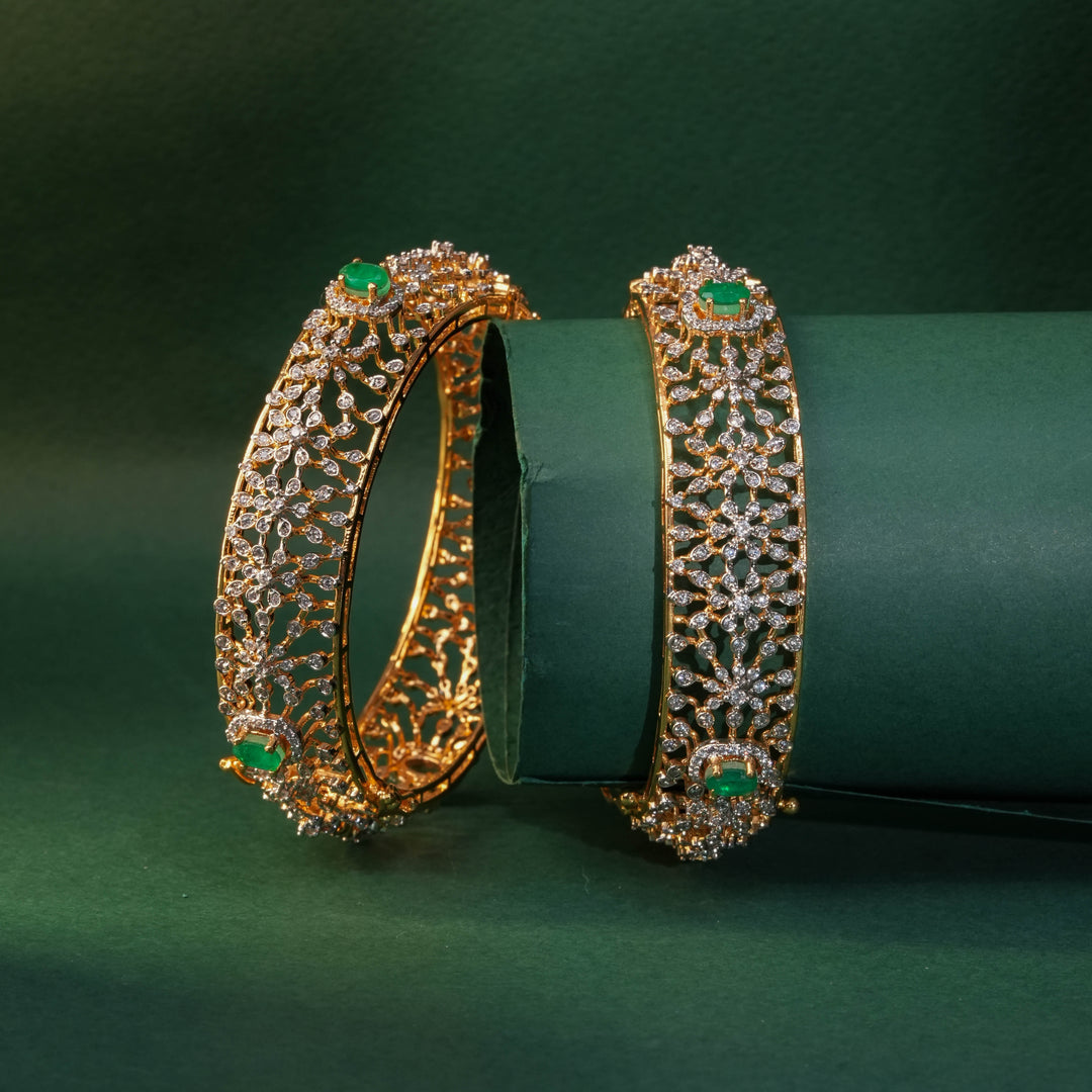 92.5 silver CZ bangles with floral motifs and gold-like finish by Sri Fine Jewellery, Hyderabad.
(https://www.srifinejewellery.com)