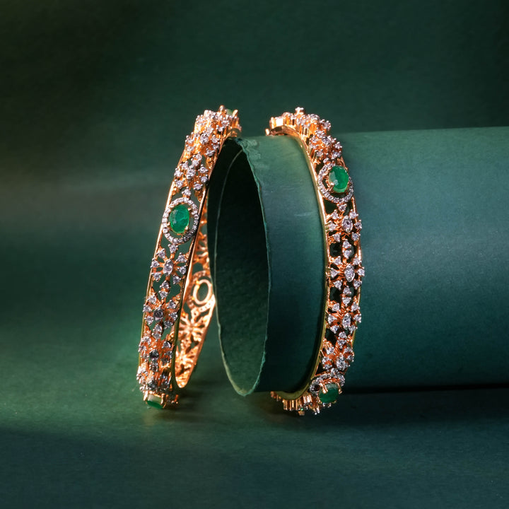 92.5 silver CZ bangles with floral motifs and gold-like finish by Sri Fine Jewellery, Hyderabad.
(https://www.srifinejewellery.com)