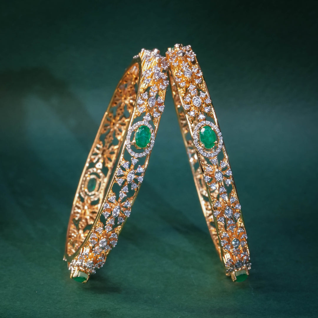 92.5 silver CZ bangles with floral motifs and gold-like finish by Sri Fine Jewellery, Hyderabad.
(https://www.srifinejewellery.com)