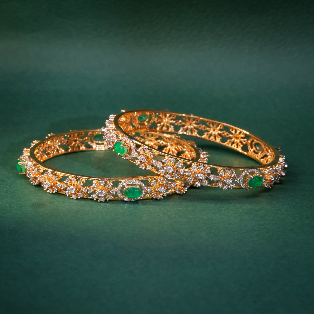 92.5 silver CZ bangles with floral motifs and gold-like finish by Sri Fine Jewellery, Hyderabad.
(https://www.srifinejewellery.com)