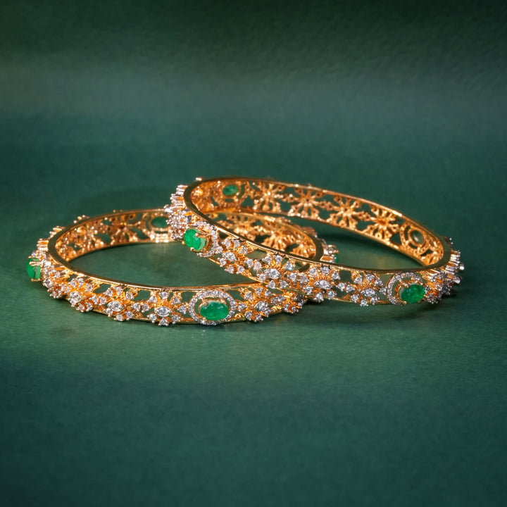 92.5 silver CZ bangles with floral motifs and gold-like finish by Sri Fine Jewellery, Hyderabad.
(https://www.srifinejewellery.com)