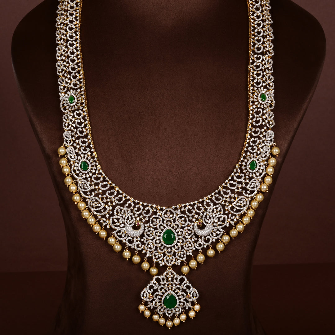 Luxury diamond-look silver cz emerald necklace with premium cz stones, semi-precious emerald stone and  pearl drops in 92.5 silver, bridal wedding jewellery with gold finish by Sri Fine Jewellery Punjagutta Hyderabad.