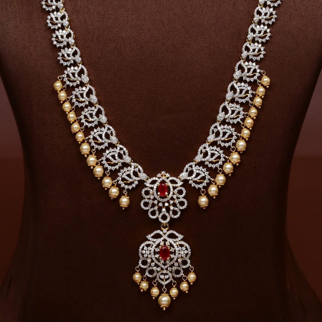 Close-up of Hriday collection of 92.5 silver long necklace with CZ stones, intricate floral motifs, and pendant design for bridal and festive wear by Sri Fine Jewellery, Hyderabad.